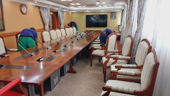 Team cleaning a large boardroom and conference chairs